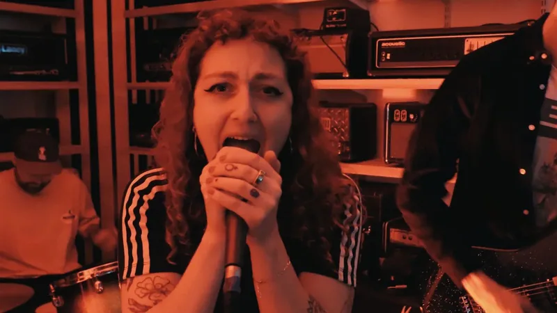 Truths video still: close-up of the singer in red light